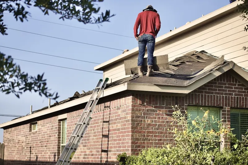 Professional roofer working on a residential roof in Blandford